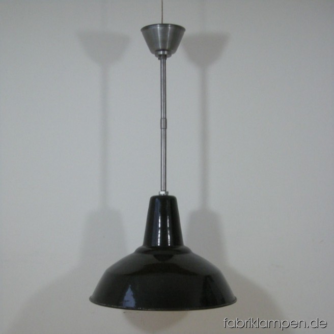 Black industrial lamp with enameled shade. Total height: as on the pictures: 82 cm (32,3 inches), with one steel tube 54,5 cm (21,5 inches). With another steel tube of 25 cm (9,8 inches), the total height can be increase up to 107 cm (42,1 inches). Height of the lamp ca. 33 cm (13 inches), diameter of the lamp ca. 44,5 cm (17,5 inches).