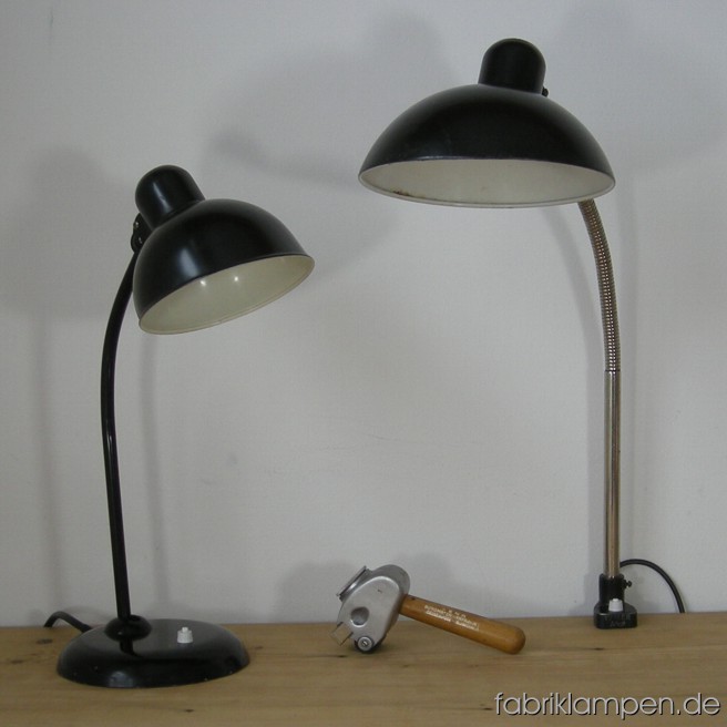 Black Kaiser Idell desk lamps in nice used condition with traces of age and use. Height ca. 46 cm (18,1 inches), diamater shade ca. 16 cm (6,3 inches); height ca. 63 cm (24,8 inches), diamater shade ca. 22 cm (8,66 inches).