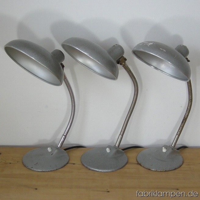 3 Old swans’s neck lamps with casted iron base. Strong traces of age and use. Height ca. 46 cm (18,1 inches), diamater shade ca. 22 cm (8,7 inches).