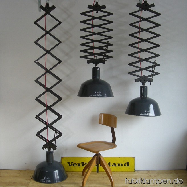 Huge scizzors lamps up to 2,5 meters. Material: steel and gray enameled sheet. Total height 70 – 250 cm (28 – 98 inches), height shades  ca. 34 cm (13,4 inches), diameter of the shades ca. 46 cm (18,1 inches). With traces of age and use.