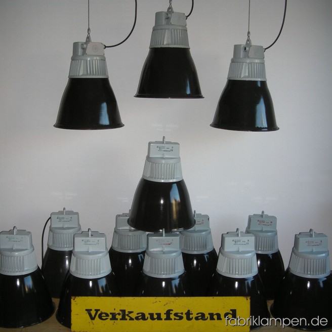 Black industrial lamps with enameled shades. Material: black enameled sheet, aluminium head. Newly electrified, with E27 sockets. Height of the lamps ca. 55 cm (21,6 inches), diameter of the shades ca. 43 cm (17 inches).