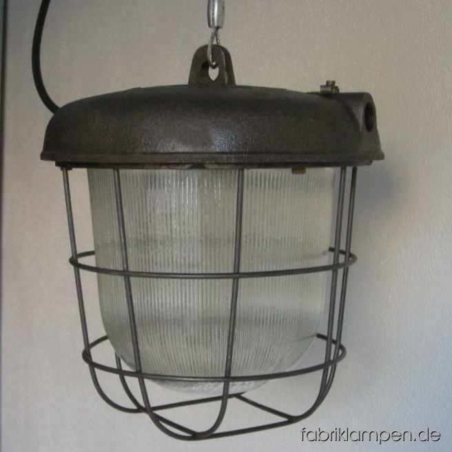 Nice industrial bunker lamp (bully). Material: casted iron, steel, glass. We have 10 pieces on stock. The lamps are cleaned and newly electrified, with ca. 2 m wire. Total height: ca. 30 cm (11,8 inches).