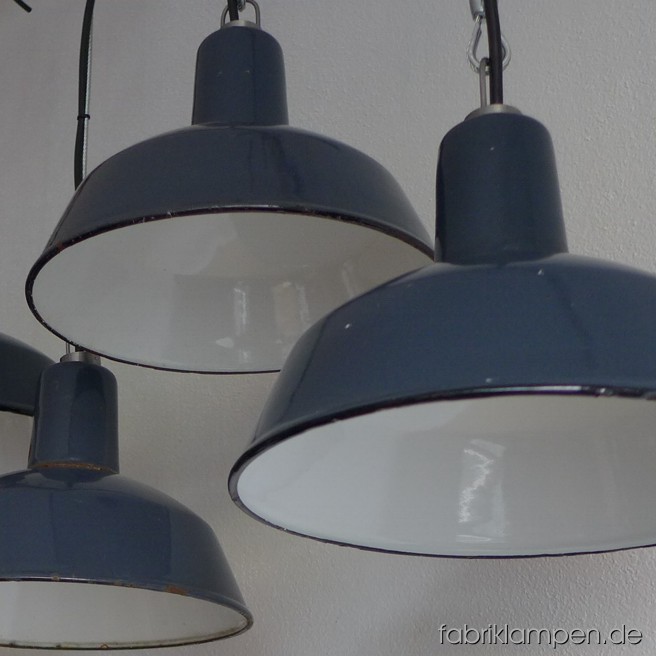 Small industrial lamps with black inscriptions. Material: blue (grayish) enameled sheet. Newly electrified, with wire-rope suspension. Height of the lamp is ca. 18 cm (7 inches), diameter of the shade is ca. 26 cm (10,2 inches).