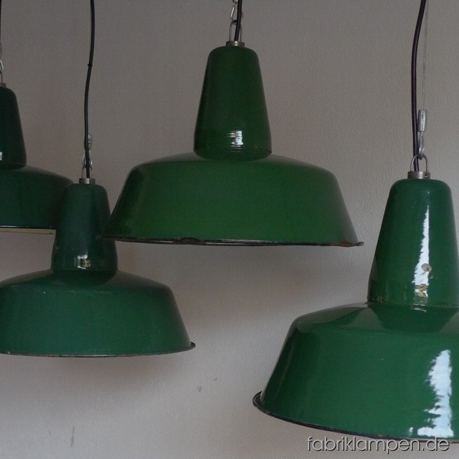 Green industrial lamps. Material: green enameled sheet. Newly electrified, with wire-rope suspension. Height of the lamp is ca. 30 cm (11,8 inches), diameter of the shade is ca. 41 cm (16 inches). 