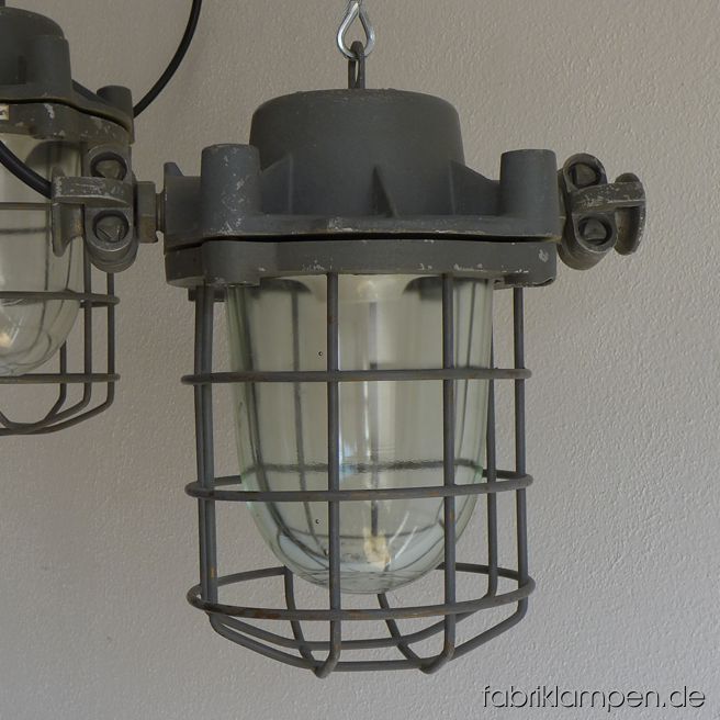 Rare gray bunker lamps. Material: gray varnished casing, safety glass and grid.  Newly electrified, with E27 sockets. We have 4 pieces on stock. Height of the lamps ca. 30 cm (11,8 inches), diameter of the lamps (without „ears“) ca. 20 cm (7,9 inches).