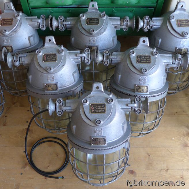 Rare pale gray bunker lamps. Material: gray varnished casing, safety glass and grid.  Newly electrified, with E27 sockets. We have 12 pieces on stock. Height of the lamps ca. 46 cm (18,1 inches), diameter of the lamps (without „ears“) ca. 28 cm (11 inches).