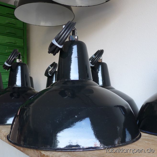 Elegant black enamel lamps from the 1930ies. The lamps have the typical traces of usage and age. Material: black enameled steel sheet. Newly electrified, with E27 sockets. We have 9 pieces on stock. Height of the lamps ca. 31 cm (12,2 inches), diameter of the shades ca. 46 cm (18,1 inches).