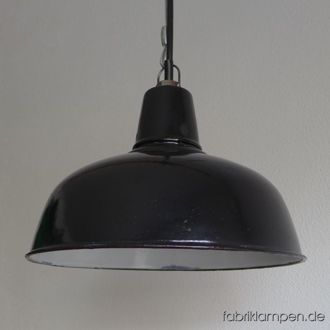 Old black enamel factory lamp from the 1930ies. We have 4 pieces in stock. The lamps have the typical traces of usage and age. Material: black (inside white) enameled steel sheet. Newly electrified, with E27 sockets. We have only 4 pieces on stock. Height of the lamps ca. 23 cm (9 inches), diameter of the shades ca. 35 cm (13,8 inches).