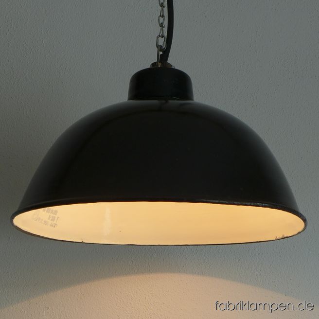 Old black LBL enamel factory lamp, produced by VEB Leuchtenbau Leipzig. The lamps have the typical traces of usage and age. Material: black (inside white) enameled steel sheet. Newly electrified, with E27 ceramic sockets. Height of the lamps ca. 22 cm (8,8 inches), diameter of the shade ca. 38 cm (15 inches).