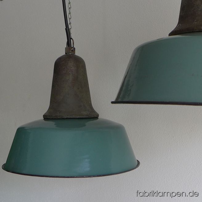 Nice old factory lamp with green, blue or gray enameled shade. Material: enameled sheet, casted iron head. Newly electrified, with E27 sockets. Height of the lamps ca. 33 cm (13 inches), diameter of the shades ca. 41 cm (16,1 inches). The lamps will be shipped with 2 m cable and suspension eye (chain or steel-tube suspension is possible for an additional charge).