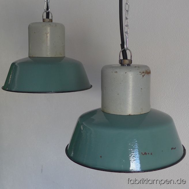 Old turquoise enamel factory lamps. The lamps have the strong traces of usage and age. Material: steel top, turquoise (inside white) enameled steel sheet. Cleaned and newly electrified, with E27 ceramic sockets. We have 7 pieces on stock. Height of the lamps ca. 23 cm (9 inches), diameter of the shades ca. 32 cm (12,6 inches).