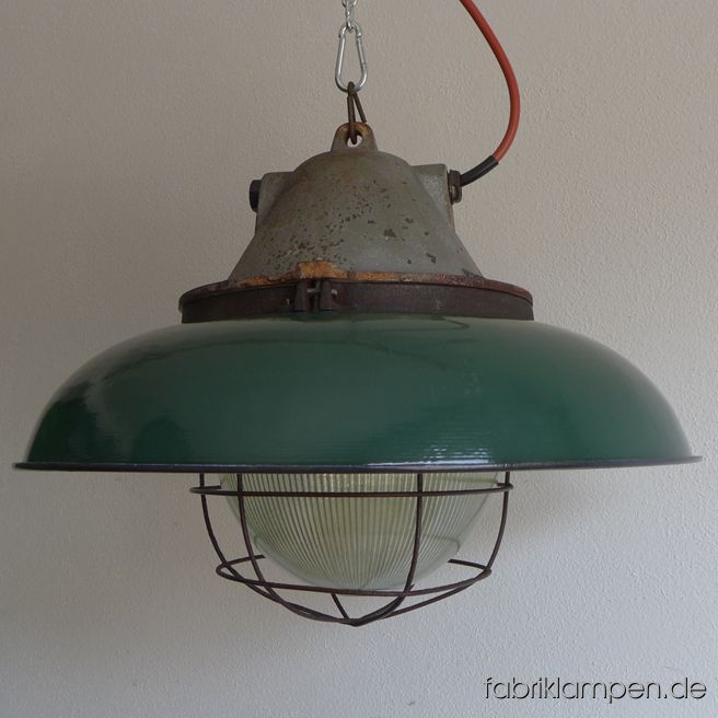 Very rare big bunker lamp with green enamel shades. It belongs to the biggest coloured enamel lamps, the diameter of the shade is 52 cm (20,5 inches), the lamp weighs 15 kgs. The lamps have the traces of age and usage. Material: casted iron top, safety glass and grid, green (inside white) enameled steel sheet. Cleaned, conserved and newly electrified, with E27 ceramic bulbholders. Height of the lamps ca. 39 cm (15,4 inches), diameter of the shades ca. 52 cm (20,5 inches).  