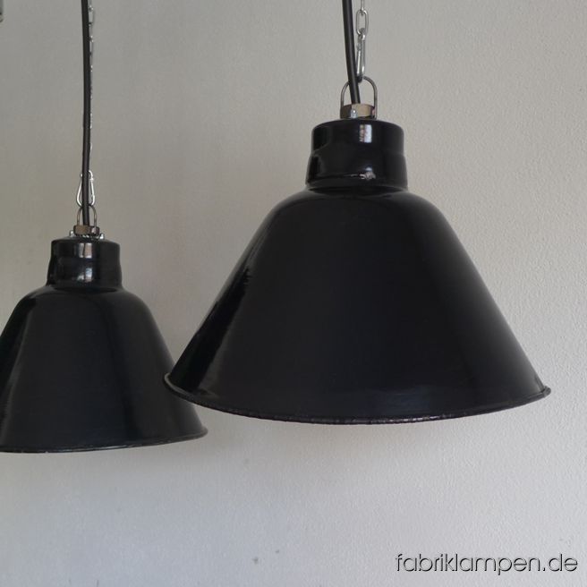 Old black industrial lamp, produced by LBL, VEB Leuchtenbau Leipzig, GDR. The asymmetric shades are elegant and functional over a long table, sideboard, bar or counter. The lamps have the typical traces of usage and age. Material: black (inside white) enameled steel sheet. Newly electrified, with E27 ceramic bulb sockets. Height of the lamp ca. 25 cm (9,8 inches), width of the shade ca. 35 cm (13,8 inches), depth of the shade ca. 26 cm (10,2 inches). The lamps can be shipped also with steel-tube suspension or textile cable (surcharge).