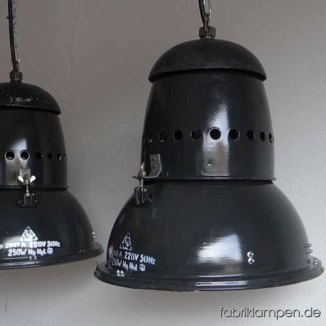 Antique factory lamps wiht nice form. The lamps have light traces of usage and age. Material: black (anthracite) enameled steel sheet, aluminium (sometimes casted iron) cap. Cleaned, newly electrified, with E27 ceramic sockets. Height of the lamps ca. 44 cm (17,3 inches), diameter of the shades ca. 44,5 cm (17,5 inches). Also in other variants on stock (with safety glass) – details & prices of these versions on request. The lamps will be shipped with 2 m cable and suspension eye (chain suspension is possible for an additional charge). 