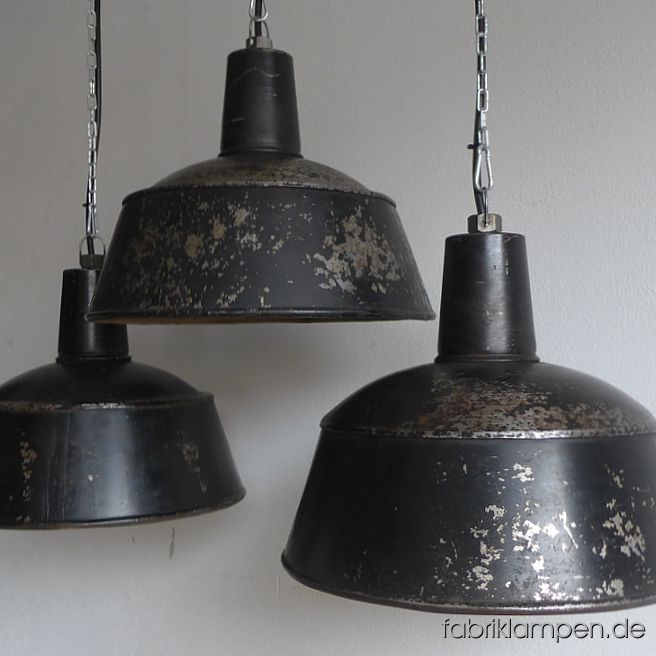 Rare old black industrial lamps from the 1930ies, 1940ies. Originally warnished, greatly weathered in the last decades. These old industrial lamps have the massive traces of usage and age. Material: black (inside white) enameled steel sheet. Cleaned and newly electrified, with E27 ceramic bulbholders. Height of the lamps ca. 32 cm (12,6  inches), diameter of the shades ca. 41 cm (16,1 inches).
