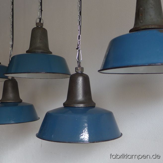 Nice old blue factory lamp with blue enameled shade, mostly hallmarked. Material: enameled sheet, casted iron head. We have also a couple of lamps in other colours (like green or grayish green) in stock. With traces of age and usage. Cleaned, newly electrified, with E27 ceramic sockets. Height of the lamps ca. 24 cm (9,4 inches), diameter of the shades ca. 32 cm (12,6 inches). The lamps will be shipped with 2 m cable and suspension eye (chain or steel-tube suspension is possible for an additional charge). 