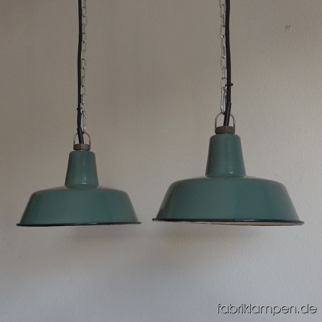Nice old pale green enamel factory lamps. Material: rare pale green (inside white) enameled steel sheet. With traces of age and usage. Cleaned, newly electrified, with E27 ceramic sockets. Height of the lamps ca. 13 cm (5,1 inches), diameter of the shades ca. 25 cm (9,8 inches). The lamps will be shipped with 2 m cable and suspension eye (chain suspension is possible for an additional charge). 