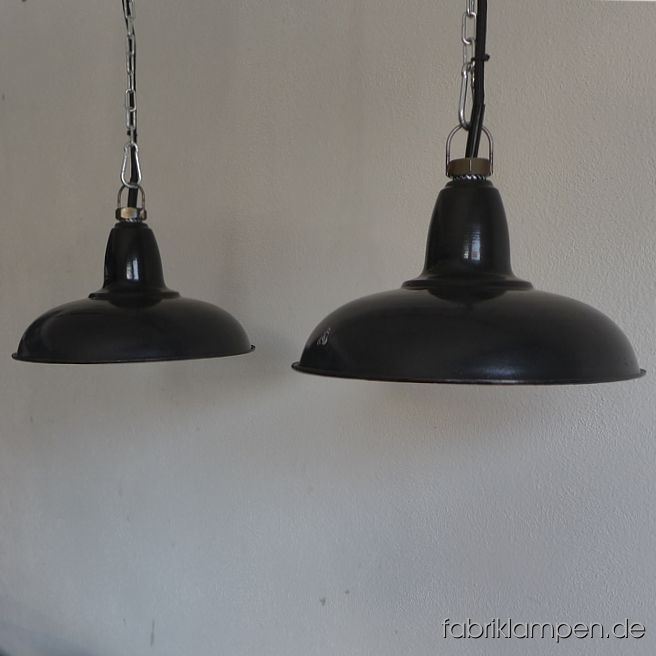 Nice old small enamel industrial lamps, hallmarked. Age: 1930-ies, very elegant and typic form. Material: black (inside white) enameled steel sheet. With some traces of age and usage. Cleaned, newly electrified, with E27 ceramic sockets. Height of the lamps only ca. 14,5 cm (5,7 inches), diameter of the shades ca. 27 cm (10,6 inches). The lamps will be shipped with 2 m cable and suspension eye (chain suspension is possible for an additional charge). 