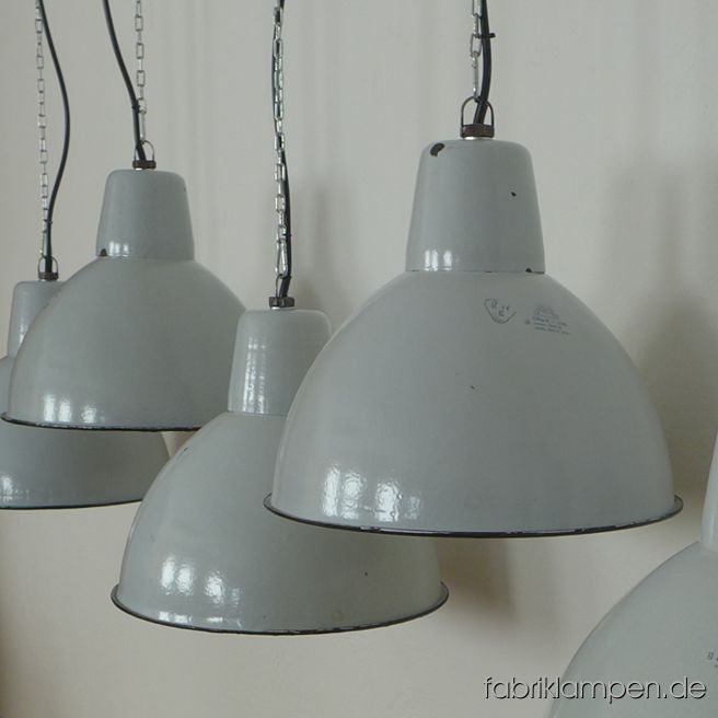 Rare old pale gray industrial lamp. The old factory lamps have some traces of usage and age. Material: pale gray (inside white) enameled steel sheet. Clenad and newly electrified, with E27 ceramic bulbholders. Height of the lamps ca. 37 cm (10,6 inches), diameter of the shades ca. 42 cm (16,5 inches). We have also the bigger version of this type in stock. 