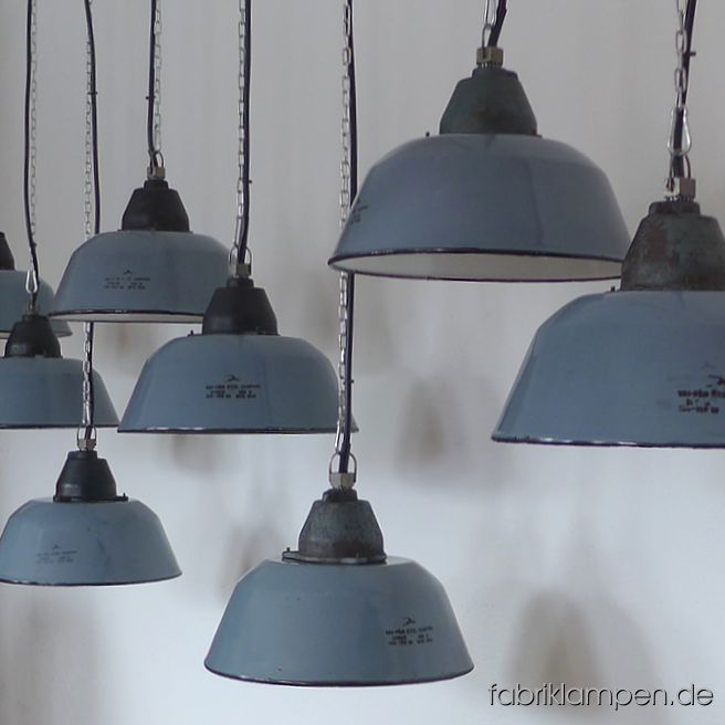 Old factory lamps. Nice old grayish blue enamel industrial lamps with casted iron top, hallmarked. The colour of the enamel shades is pale grayish blue. We have these lamps also in blue and pale gray in stock. Material: grayish blue (inside white) enameled steel sheet, casted iron head. With traces of age and usage. Cleaned, newly electrified, with E27 ceramic sockets. Height of the lamps ca. 23 cm (9 inches), diameter ca. 36 cm (14,2 inches). The lamps will be shipped with 2 m cable and suspension eye (chain or steel-tube suspension is possible for an additional charge). 