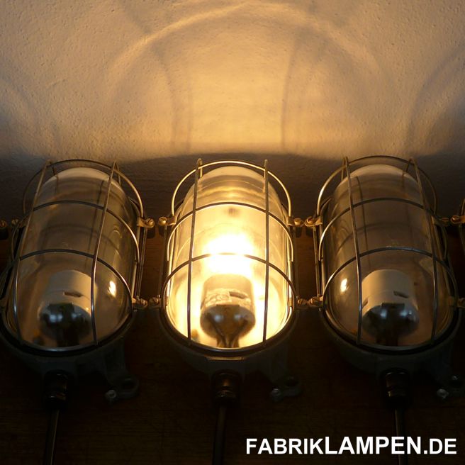 Old wall lamp – one of the smallest wall lamps with metal casing. Material: aluminium casing, safety glass and steel grid. The lamps have the light traces of usage and age, they are cleaned and conserved. Newly electrified, with E27 ceramic sockets. Lenght/height: 26 cm (10,2 inches), width 14 cm (5,5 inches), depth 13 cm (5,1 inches). 