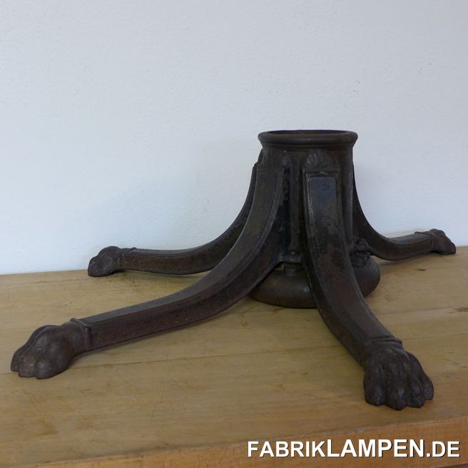 Old big Christmas tree stand. The stand is shaped in the shape of a tree trunk, with root-shaped branching feet. The feet end in paws. Gründerzeit, late XIX. Century or turn of the century.Massive piece, the biggest width is 93 cm, in the other direction 75 cm, the height is 27 cm. The weight is 31 kg. The aperture has a considerable diameter of 12.8 cm, Christmas trees up to 4 meters in height fit in easily.Condition: preserved condition. The set screw is missing, the water tank has a long crack and is accordingly leaking. Despite missing screw, it can be used, we tested it a year ago and fixed the Christmas tree with wedges. The surface has been conserved, in some places remains of the previous color can be recognized (black, gray).As a benchmark, we took some old Christmas tree stands, these have an aperture of ca. 5 cm. 