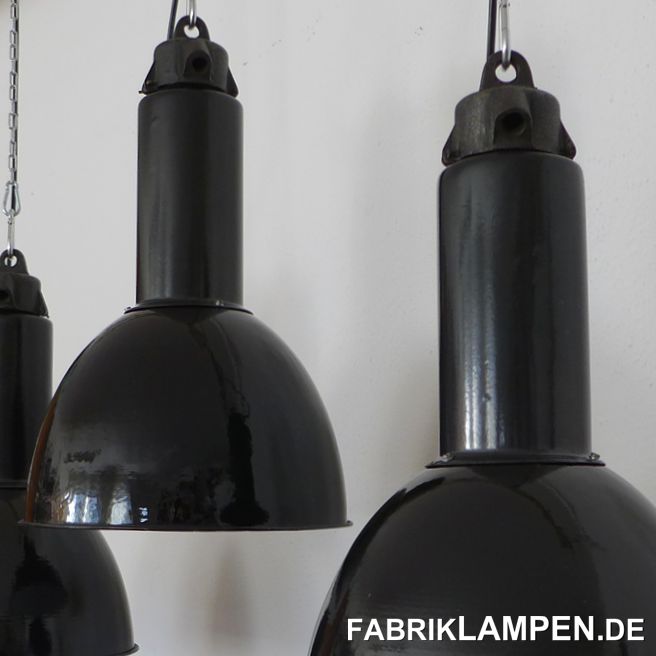 Old black industrial lamp in nice form, rare. These old lamps have some traces of usage and age. Material: black (inside white) enameled steel sheet, casted iron. Restored: cleaned and conserved. Newly electrified, with E27 ceramic sockets. Height of the lamps ca. 46 cm (18,1 inches), diameter of the shades ca. 31 cm (12,2 inches).These old factory lamps will be shipped with 2 m cable and suspension eye (textile cable, chain or steel tube suspension is possible for an additional charge).Total height: ca. 53,5 cm (21,1 inches), diameter of the shade ca. 35 cm (13,8 inches). 