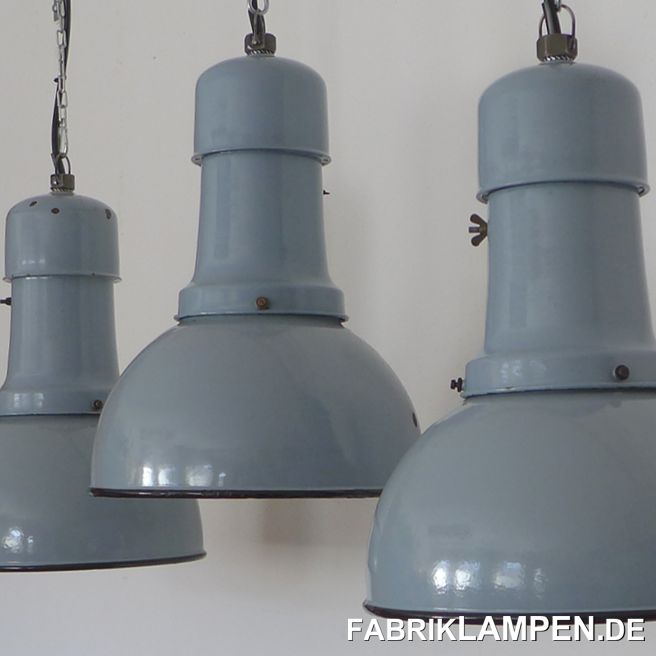 Old pale blue industrial lamp, enamel. Classic three-part design.These old lamps have some traces of usage and age. Material: light blue (inside white) enameled steel sheet, with original brass screws.Restored: cleaned and conserved. Newly electrified, with E27 ceramic sockets. Height of the lamps ca. 46,5 cm (18 inches), diameter of the shades ca. 35 cm (14 inches). Weight: only 3 kg. These old factory lamps will be shipped with 2 m cable and suspension eye (textile cable, chain or steel tube suspension is possible for an additional charge). 