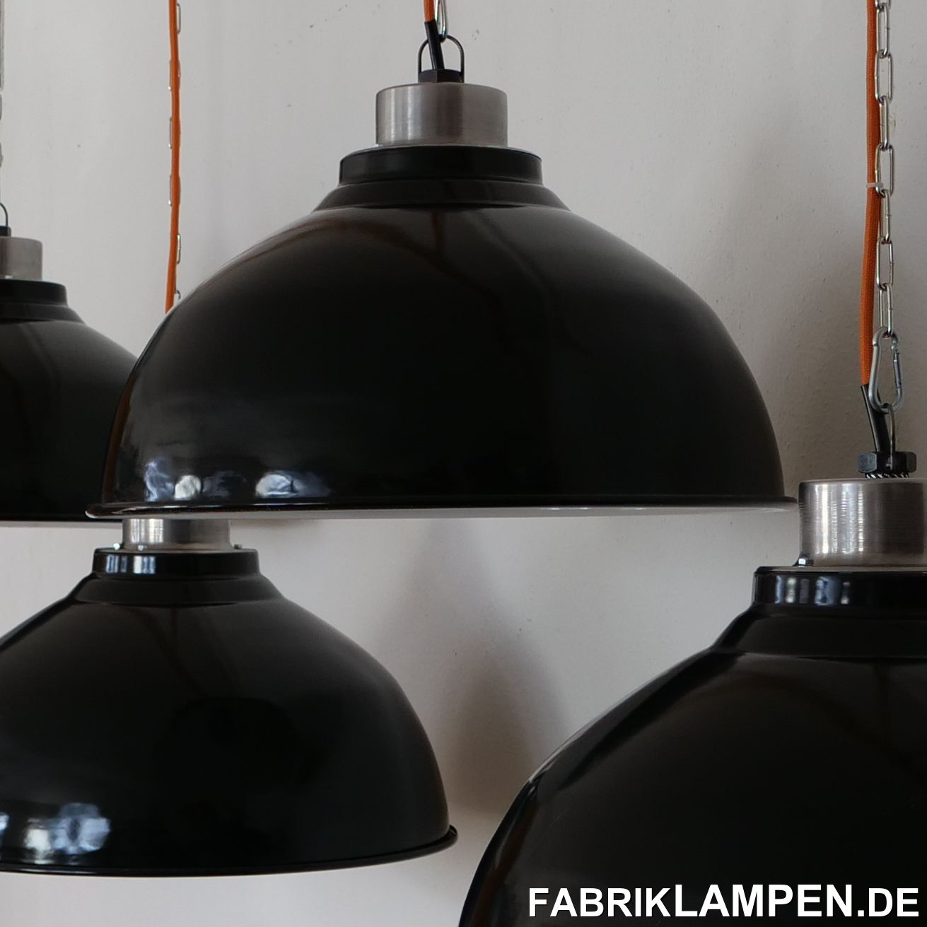  Old black industrial lamps with a very large enamel shade.These old large enamel lamps come from France and are among the last enamel lamps that were made - back then.These beautiful factory lamps have the usual traces of the past decades such as chipping, scratches, discoloration, etc. They have been restored: cleaned, preserved and re-electrified, with new E27 ceramic sockets.Material: black (white inside) enameled sheet steel, top made of non-enameled steel.The dimensions: height of the lamps approx. 33.5 cm (13,2 inches, without hanging loop), diameter approx. 53 cm (20,9 inches). The diameter is very large, but the height of the lamp is relatively low: they are also suitable for rooms with normal interior height (above tables, counters, etc.).The old industrial lamps are supplied with a 2 meter textile cable of your choice (other lengths are of course possible) and a solid hanging loop for safe hanging. The lamps can also be supplied with chain or tubular steel suspension for an additional charge. We can also offer canopies. 