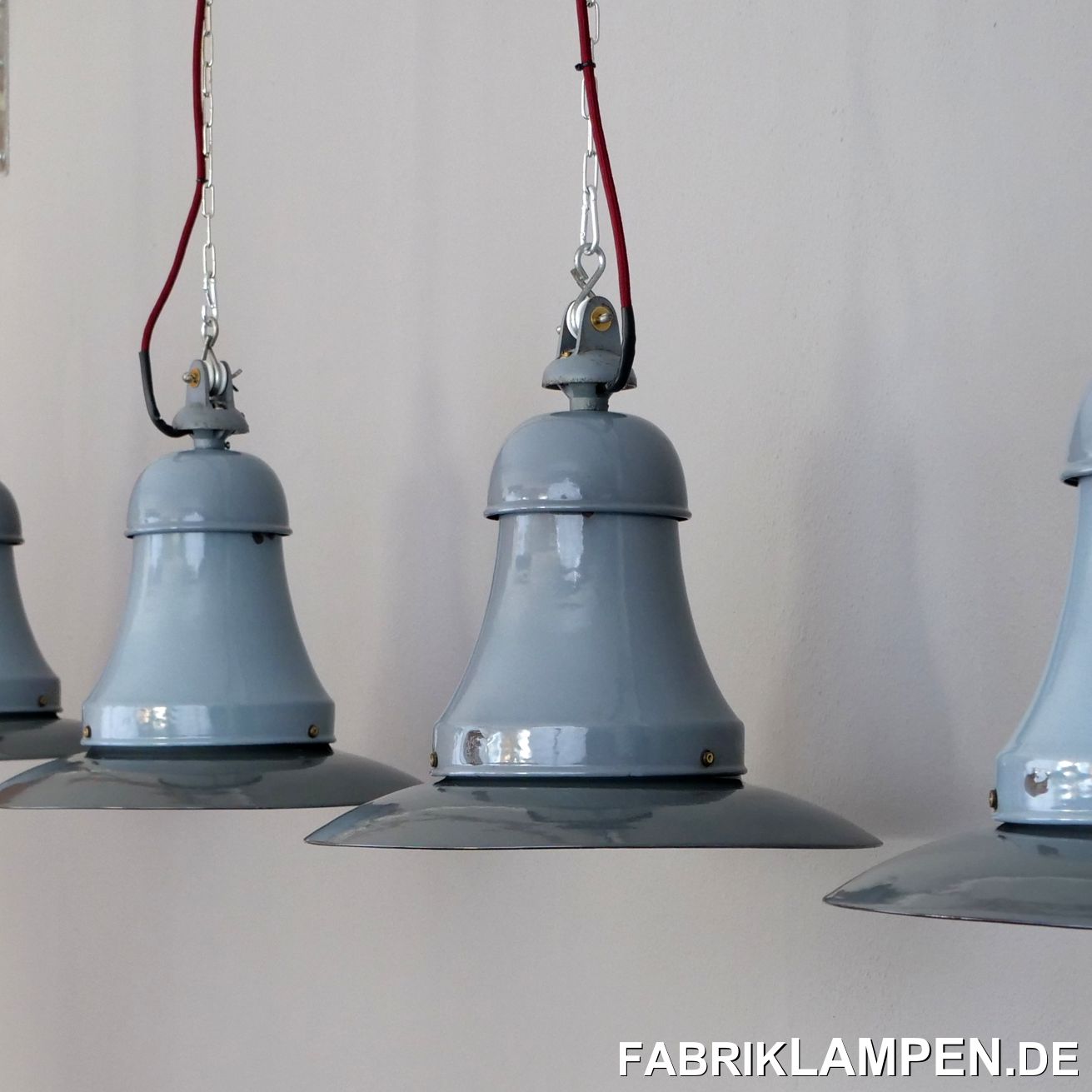  Old industrial lamps, factory lamps with two bulbholders from Siemens. We recently bought these lamps from an old hall in Hessen. The lamps were on duty until the last minute in the heated hall and accordingly they are very well preserved for their age. The original suspensions with the porcelain rolls are also available. These lamps were usually used under harsh conditions and have massive signs of use - this condition in such a quantity is very rare these days.The factory lamps have very little traces of the past decades (chipping, rust spots, scratches, discoloration, etc.), primarily at the bottom of the screws. The shades are darker, the necks lighter - Lamps with parts in deliberately different colors are typical of the German production of the time. They have been restored: cleaned, preserved and newly electrified, with new E27 ceramic sockets.Material: light blue / gray (white inside) enameled steel sheet.The old industrial lamps are supplied with a 2 meter textile cable of your choice (other lengths are of course possible) and a solid hanging loop for safe hanging. For a surcharge, the lamps can also be supplied with chain or tubular steel suspension. We can also offer canopies.The dimensions: height of the lamps approx. 40 cm (15,7 inches with suspension), diameter approx. 42 cm (16,5 inches), weight approx. 3 kg. We also have these lamps in stock with a diameter of 30 cm (with one socket), some with glasses - contact us for prices and further details! 
